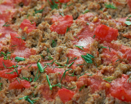 Lahmacun - round, thin piece of dough topped with minced meat and minced vegetablesの写真素材