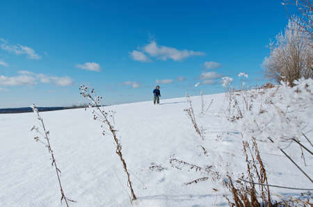 Winter landscape. Little boy playing in the snowの写真素材
