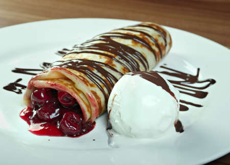 stuffed pancakes with with cherries and ice creamの写真素材