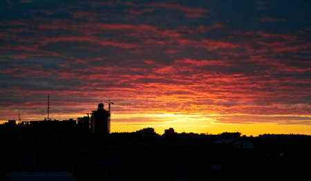 silhouette crane on building at sunsetの写真素材