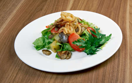 Salad with fried onions, potatoes and mushroomsの写真素材