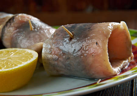 Rollmops -  pickled herring fillets, rolled slices of onion, pickled gherkin.