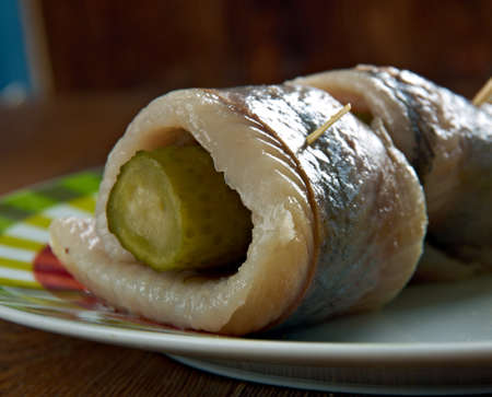 Rollmops -  pickled herring fillets, rolled slices of onion, pickled gherkin.の写真素材