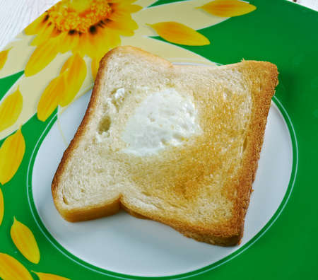 Egg in the basket - egg fried in a hole of a slice of bread.の写真素材