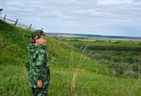 young child boy traveller on the background country side on natural backgroundの写真素材