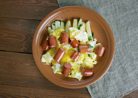 Huevos rotos con chistorra.scrambled eggs with sausage and potatoes. Mexican style.の写真素材