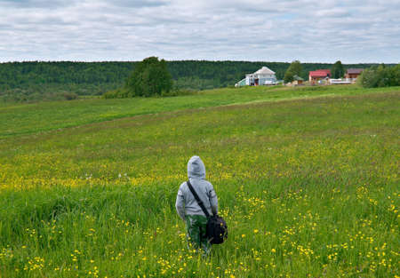 young child boy traveller on the background country side on natural backgroundの写真素材