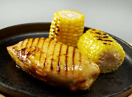 Grilled chicken breast with cornの写真素材