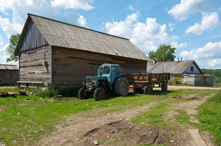 Farm tractor, North Russian village. Kenozerye. Arkhangelsk region, Russiaの写真素材