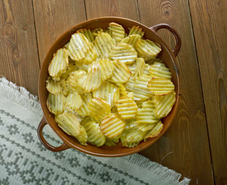 valkosipuliperunat -  Finnish baked potatoes with sour creamの写真素材