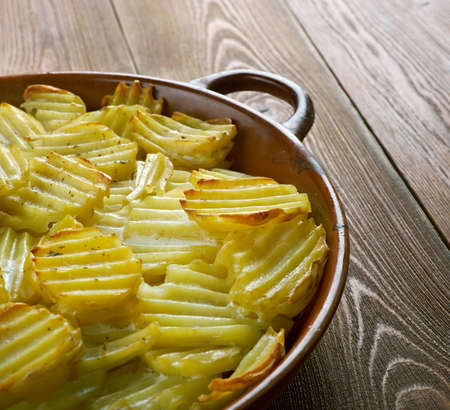 valkosipuliperunat -  Finnish baked potatoes with sour creamの写真素材