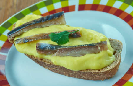 Scotch woodcock -savoury consisting of creamy, lightly scrambled eggs with anchovy served on toast.の写真素材