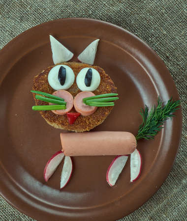 creative food concept  - cat made of burger, sausages, radishes and dill. kids menuの写真素材