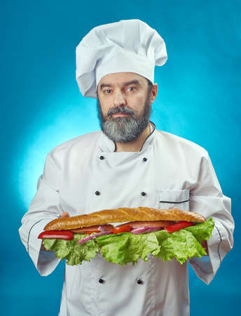 chief cook  holding  big sandwich. isolated on whiteの写真素材