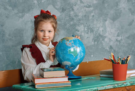 Elementary emotional schoolgirl at their vintage  desk , Retro conceptの写真素材