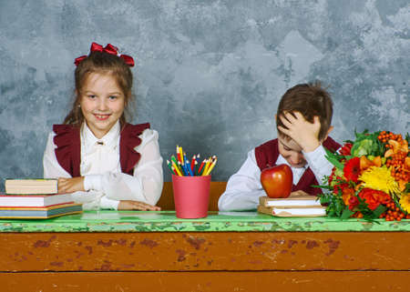 Elementary emotional school kids working at their vintage  desk , Retro concept