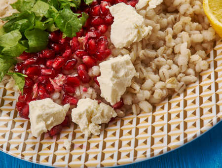 Egyptian cuisine . Traditional  egyptian Barley Salad with Pomegranate Vinaigrette,feta cheese