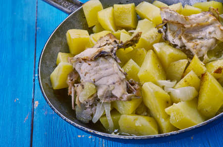 Rustic baked chicken with potatoes a frying pan.の写真素材