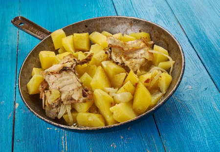 Rustic baked chicken with potatoes a frying pan.の写真素材