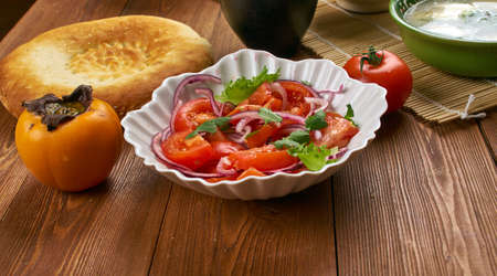 Tajik cuisine, shakarob, Fresh salad with tomatoes onions and coriander Traditional assorted Tajik  dishes, Top view.の写真素材