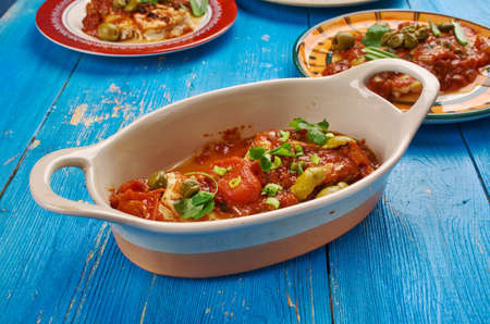 Tuscan Baked Fish - quick saute of onions, garlic,  spinach, and tomatoes is topped with sauteed fish.の写真素材