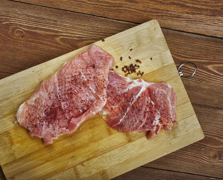 Raw cut meat on a wooden board. Pork chunks for chops , cooking pork chop, の写真素材
