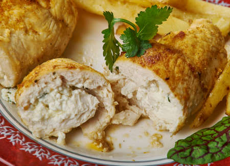 Chicken fillet  rolls stuffed with feta cheese and greensの写真素材