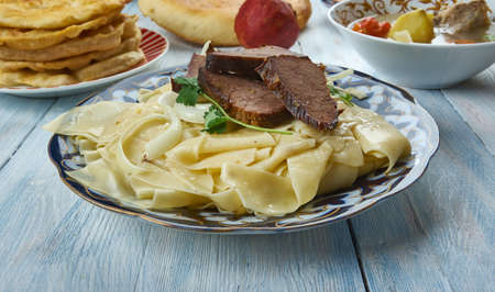 Beshbarmak, boiled meat is finely chopped with knives, mixed with boiled noodles, and spiced with onion sauce, Kazakhstan cuisine, Traditional assorted dishes, Top view.の写真素材