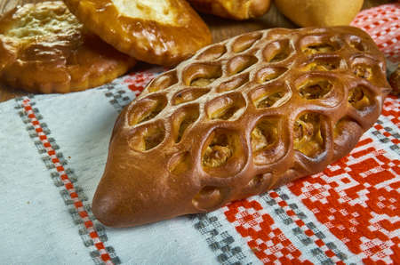 Pirog, Russian traditional pies piroshki , assorted pastry: dishes, Top view.Savoury versions may consist of meat, fish, mushrooms, cabbage, rice, buckwheat groats or potato.の写真素材