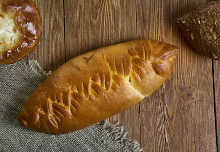Coulibiac, Russian traditional pies piroshki , assorted pastry: dishes, Top view.with salmon or sturgeon, rice or buckwheat, hard-boiled eggs, mushrooms, onions, and dill.の写真素材