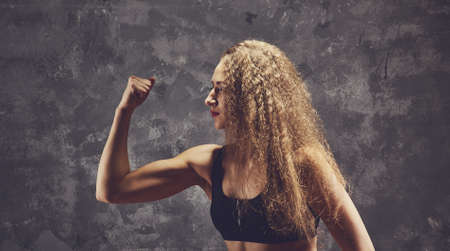 Sporty female blonde girl showing off her perfect bodyの写真素材