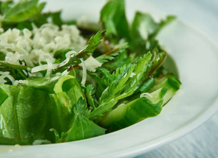 Spring salad with herbs, dandelion, nettle and cheese, vlose up