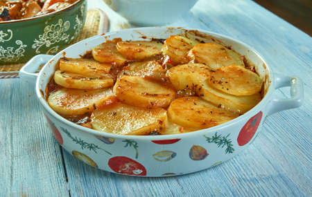 Tumbet - traditional vegetable dish from Majorca,  combines layers of sliced potatoes, aubergines...
