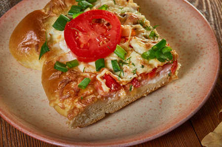 Russian pies old traditional Pirog vekoshnik with ham, tomatoes and cottage cheeseの写真素材