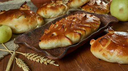 Russian pies old traditional Pirog piroshki  with cabbage and meat, in the form of figures of a...