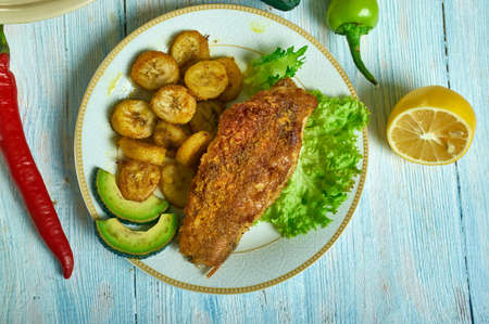 Jerk spiced fish, Caribbean cuisine, Traditional assorted  dishes, Top view.