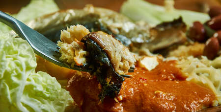Kenkey with fried fish and chili pepper, Ghanaian cuisine, Traditional assorted African dishes, Top...