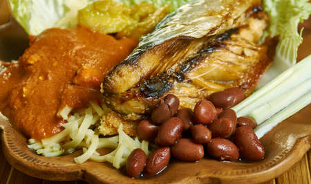 Kenkey with fried fish and chili pepper, Ghanaian cuisine, Traditional assorted African dishes, Top view.の写真素材