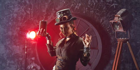Portrait of a beautiful steampunk girl with watch and flask, model in the style of a steampunk in a beautiful creative studio. Fashion, styleの写真素材