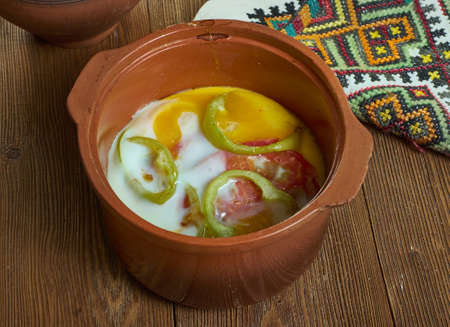 Gyuveche kaskaval, Bulgarian baked egg with tomatoes, paprika, feta and fried onions