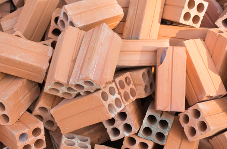 Soft focused picture of Group of Red bricks clay for construction in sun light