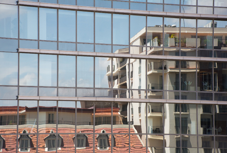 Cityscapes view from Reflection of the building with the mirror of another building.