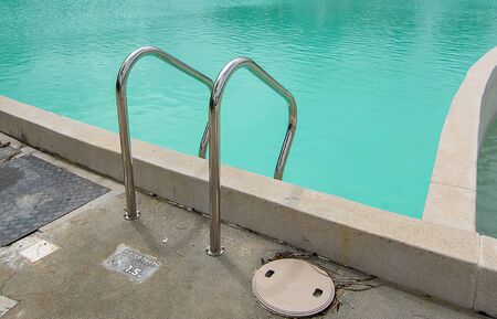 Stainless steel Stairs down to the pool,Pool handrails side of swimming pool .の写真素材