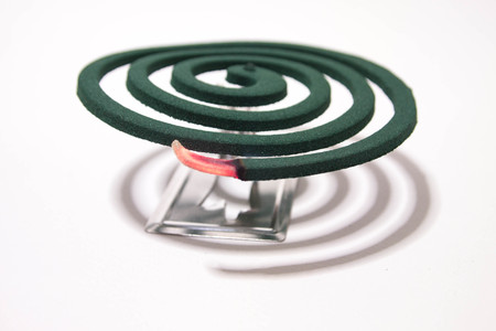 Mosquito repellent with red fire on white background