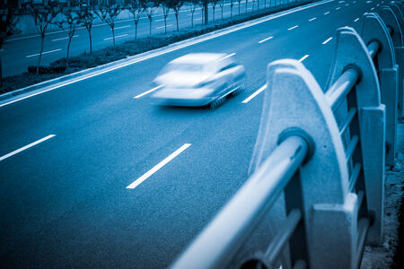 On urban roads fast moving carの写真素材