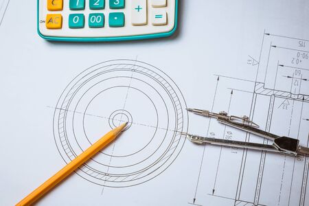 Architectural blueprints, blueprint rolls and a drawing instruments on the worktableの写真素材