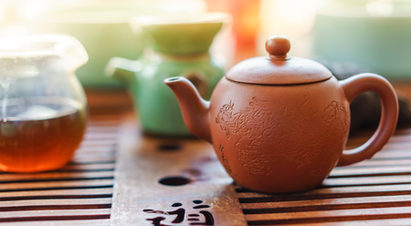 clay teapot and cups of teaの写真素材