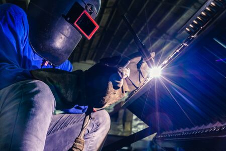 sparks while welder uses torch to welding