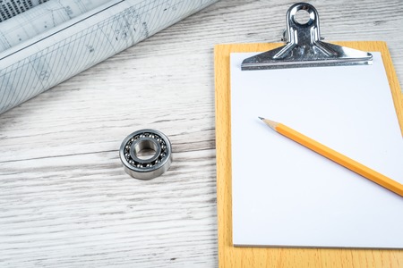 Some drawings, pencil and pen on drafting near cup of teaの写真素材