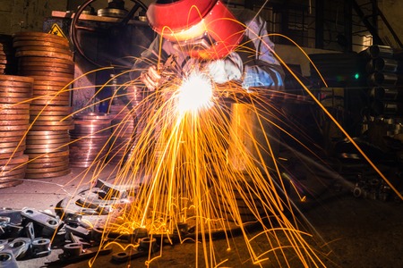 sparks while welder uses torch to weldingのeditorial素材